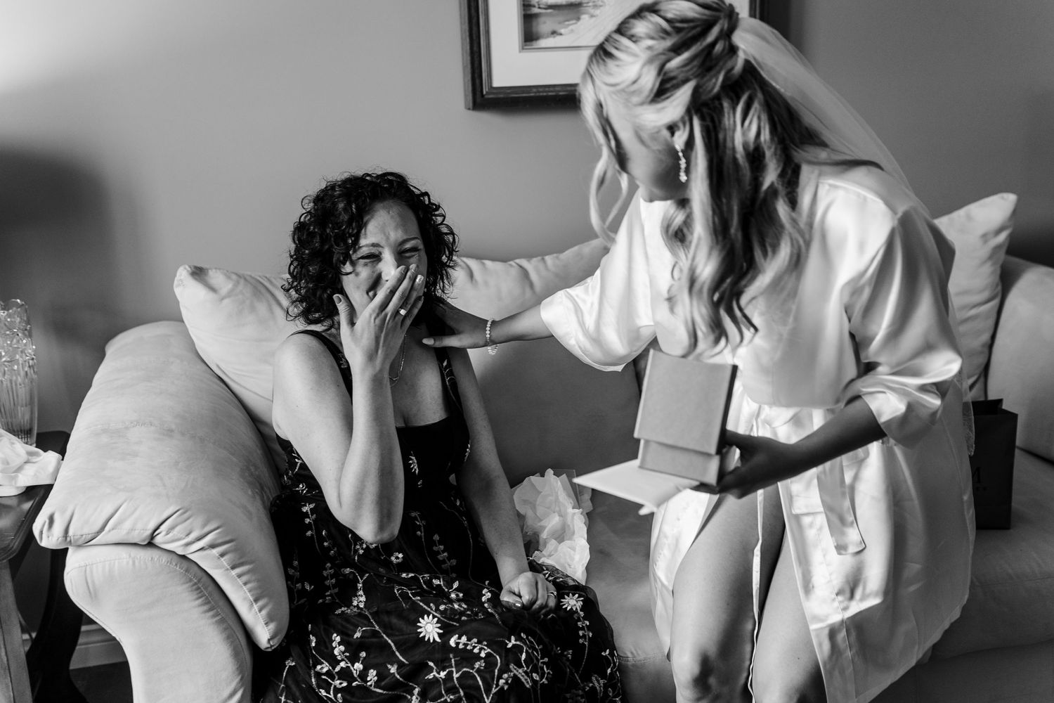 Black and white series of emotional candid moments during wedding preparations.