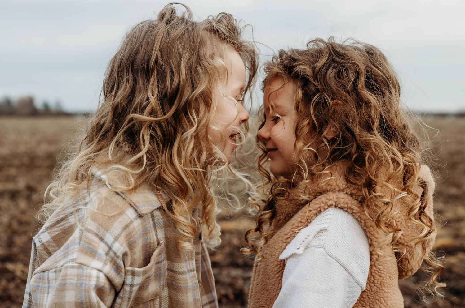 siblings sharing a sweet adorable moment during a natural and relaxed family photoshoot in Shrewsbury, Shropshire
