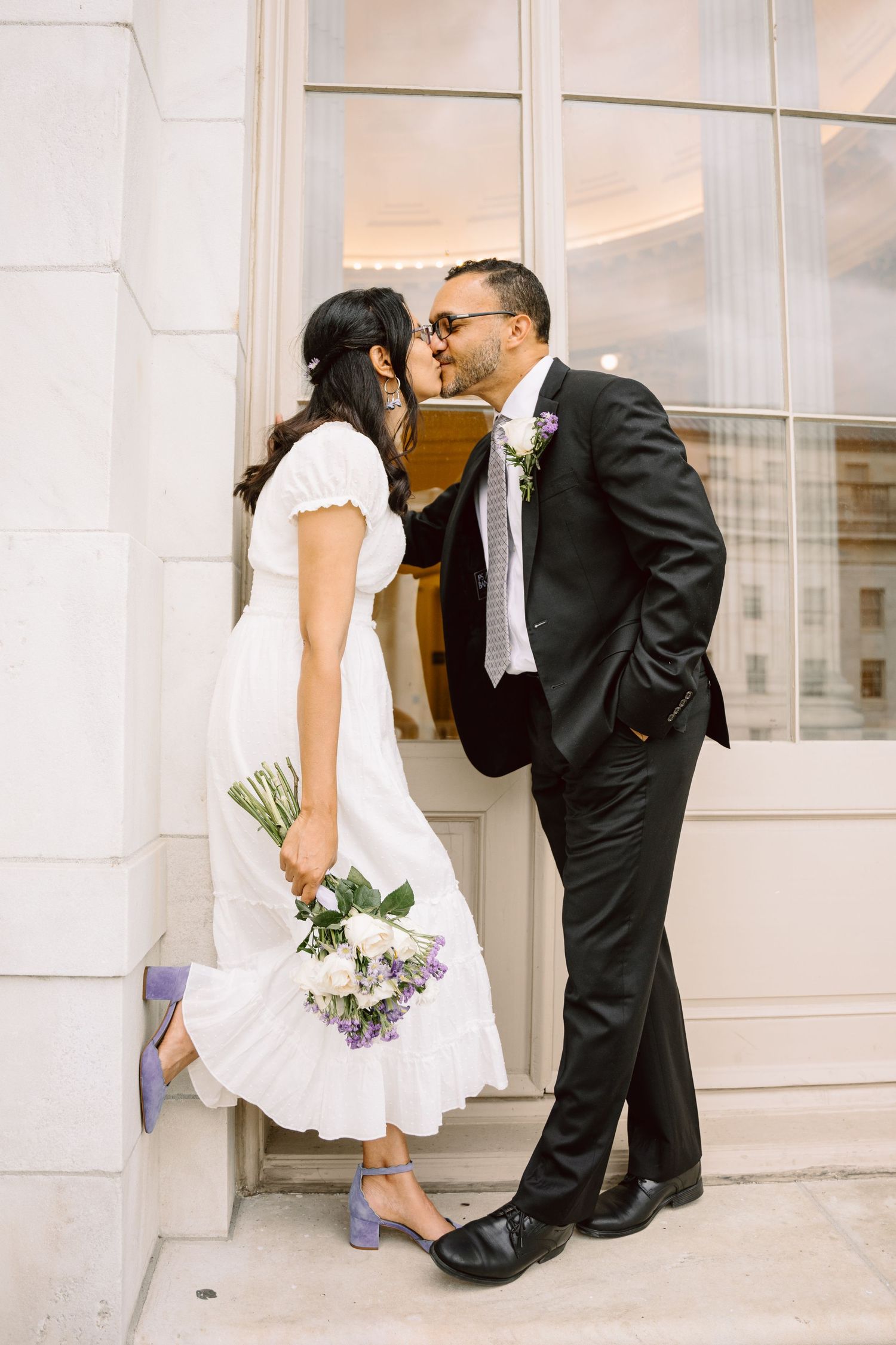 A bride and groom share a romantic kiss in front of a white building in a series of three artistic wedding photos.