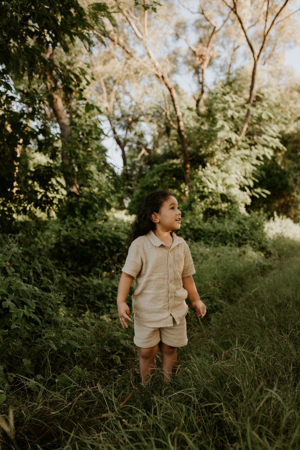 Young boy admiring the green bushes in Mount Isa