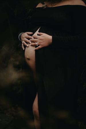 Close-up artistic shots of hands and jewelry in dark moody lighting.