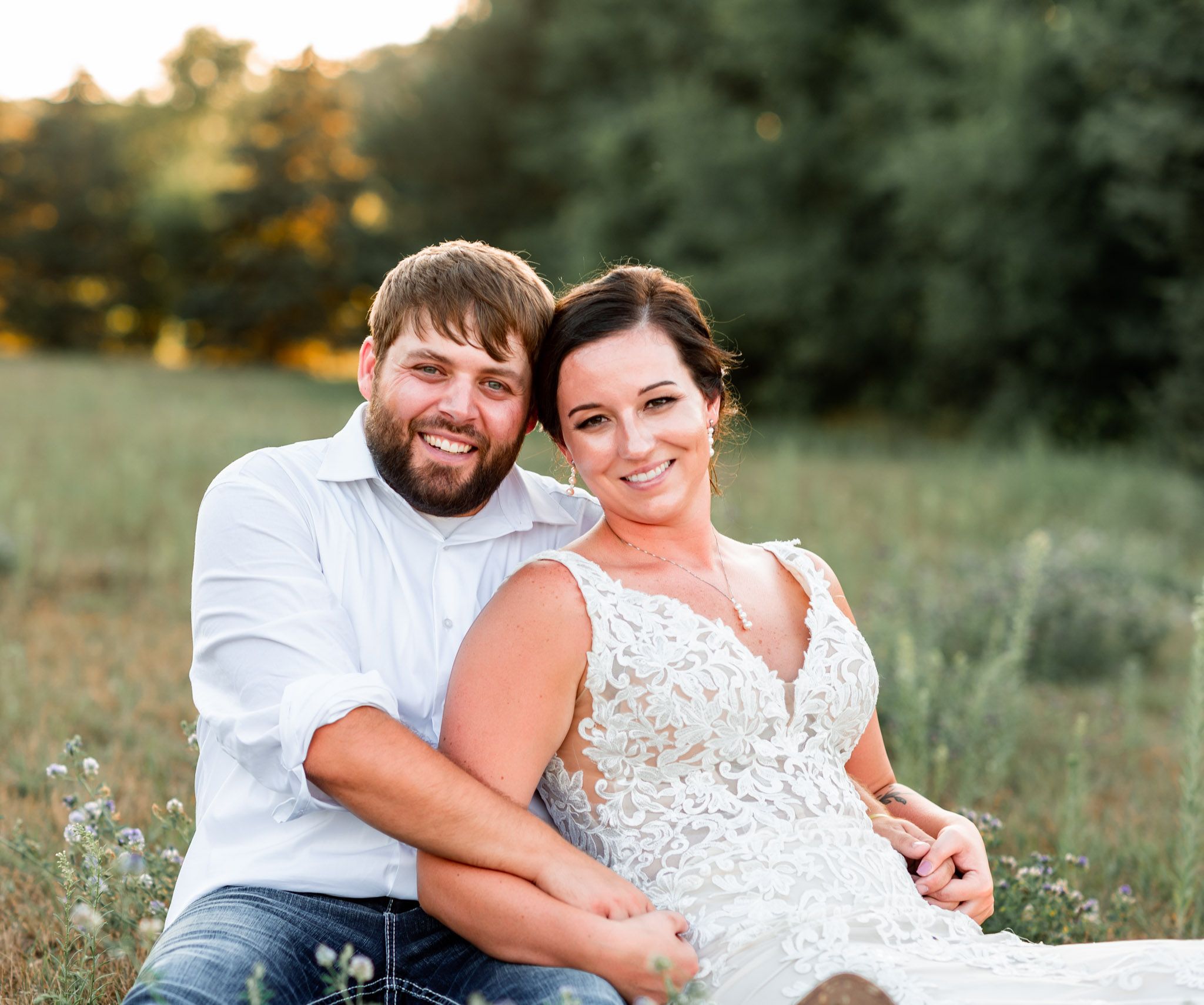 Happy couple shares joyful moment during casual outdoor wedding photoshoot.