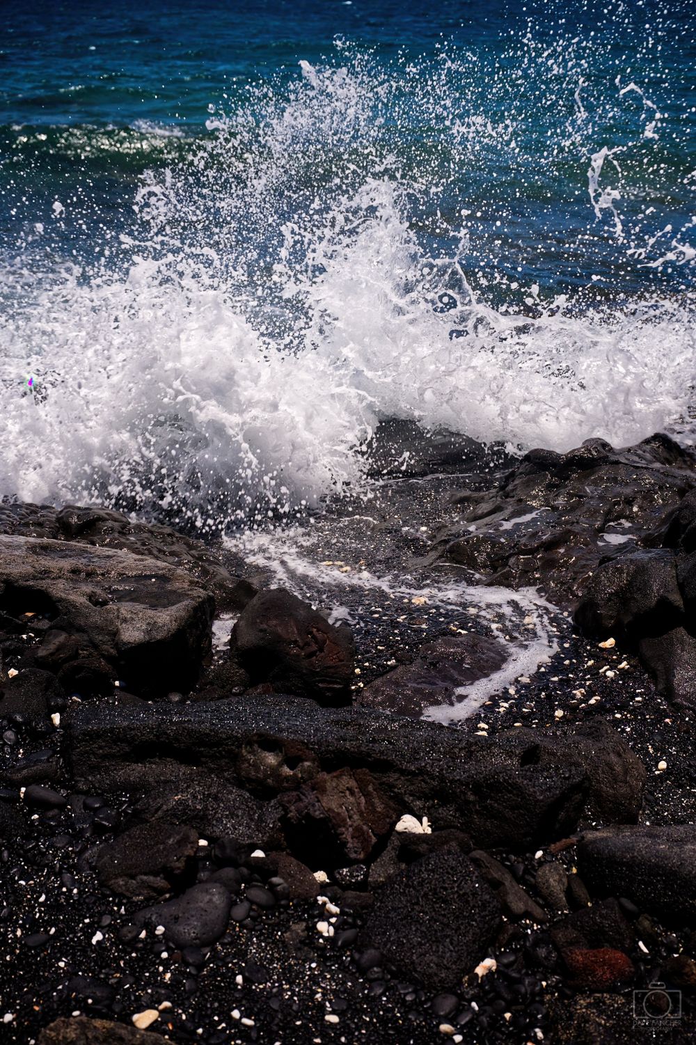 Waves crashing over rocks and creating a small stream