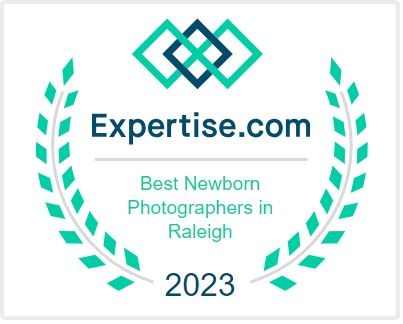 Expertise.com award badge for Best Newborn Photographers in Raleigh 2023 featuring teal geometric logo and wreath.