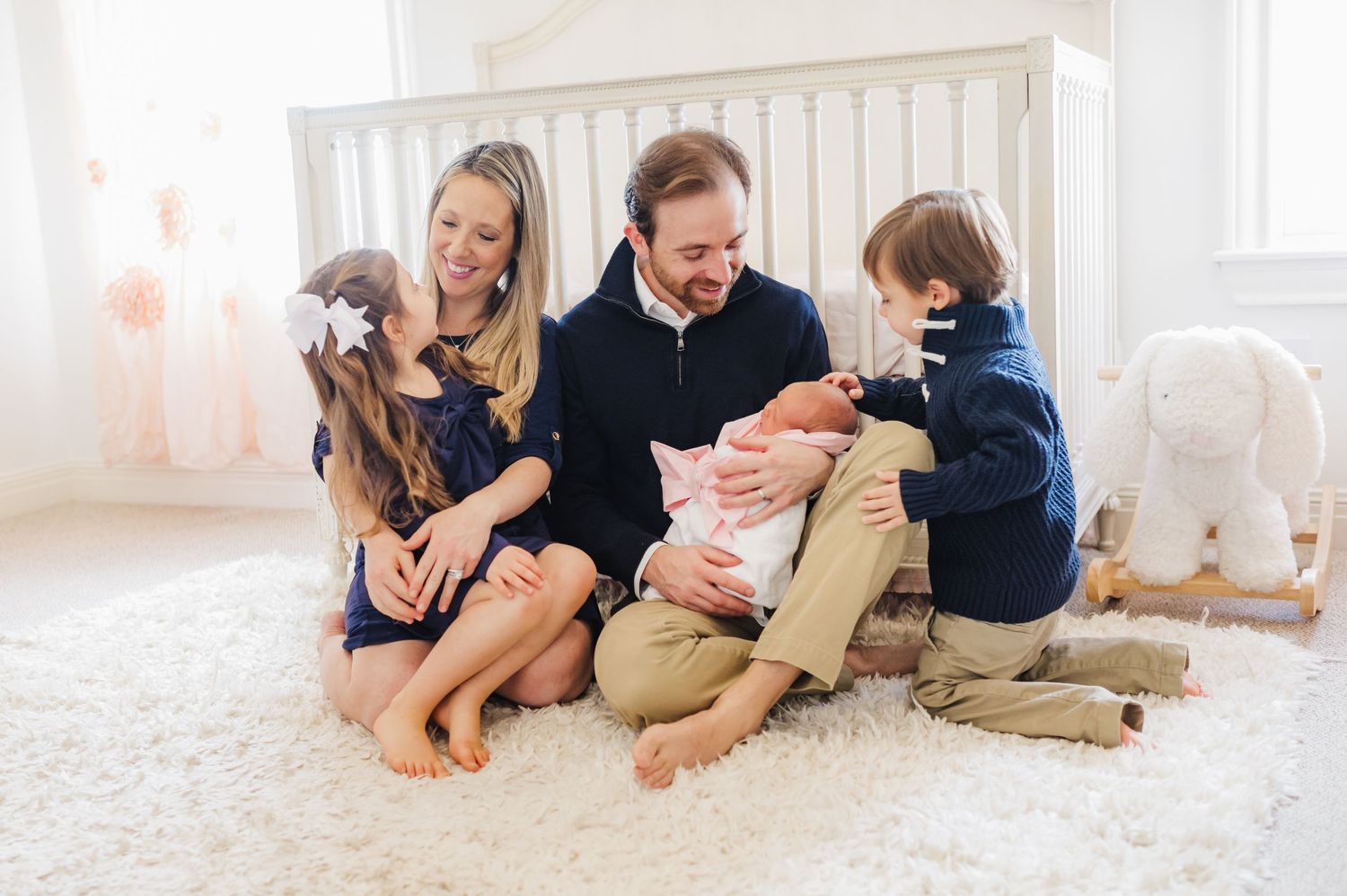casual light and bright in home newborn session with a happy family of five in houston texas