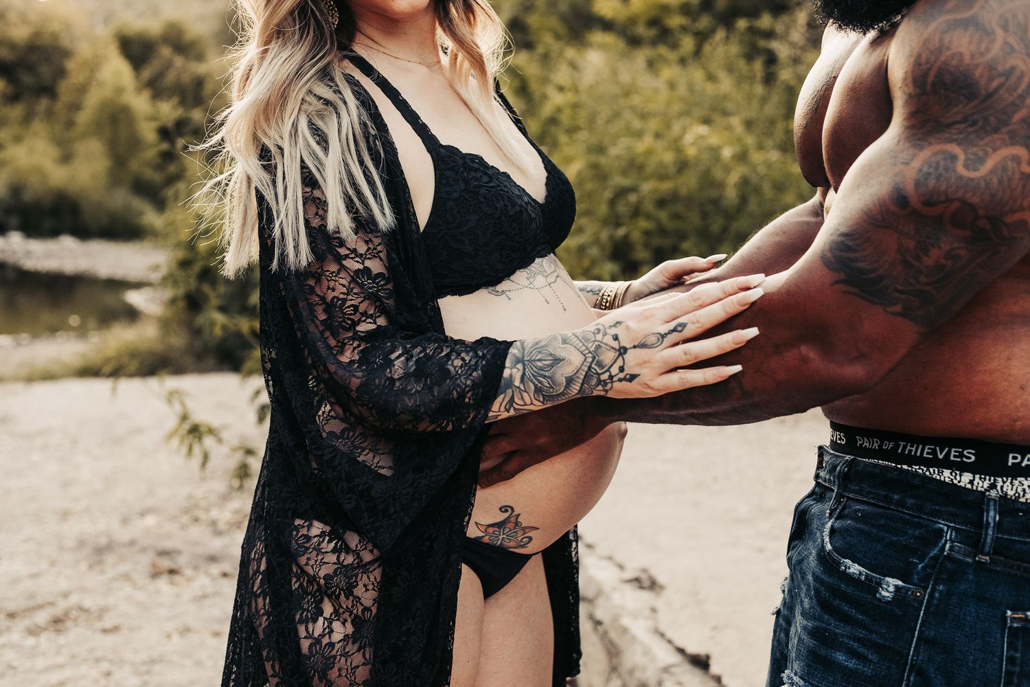 Close-up of father-to-be holding expecting mother's belly