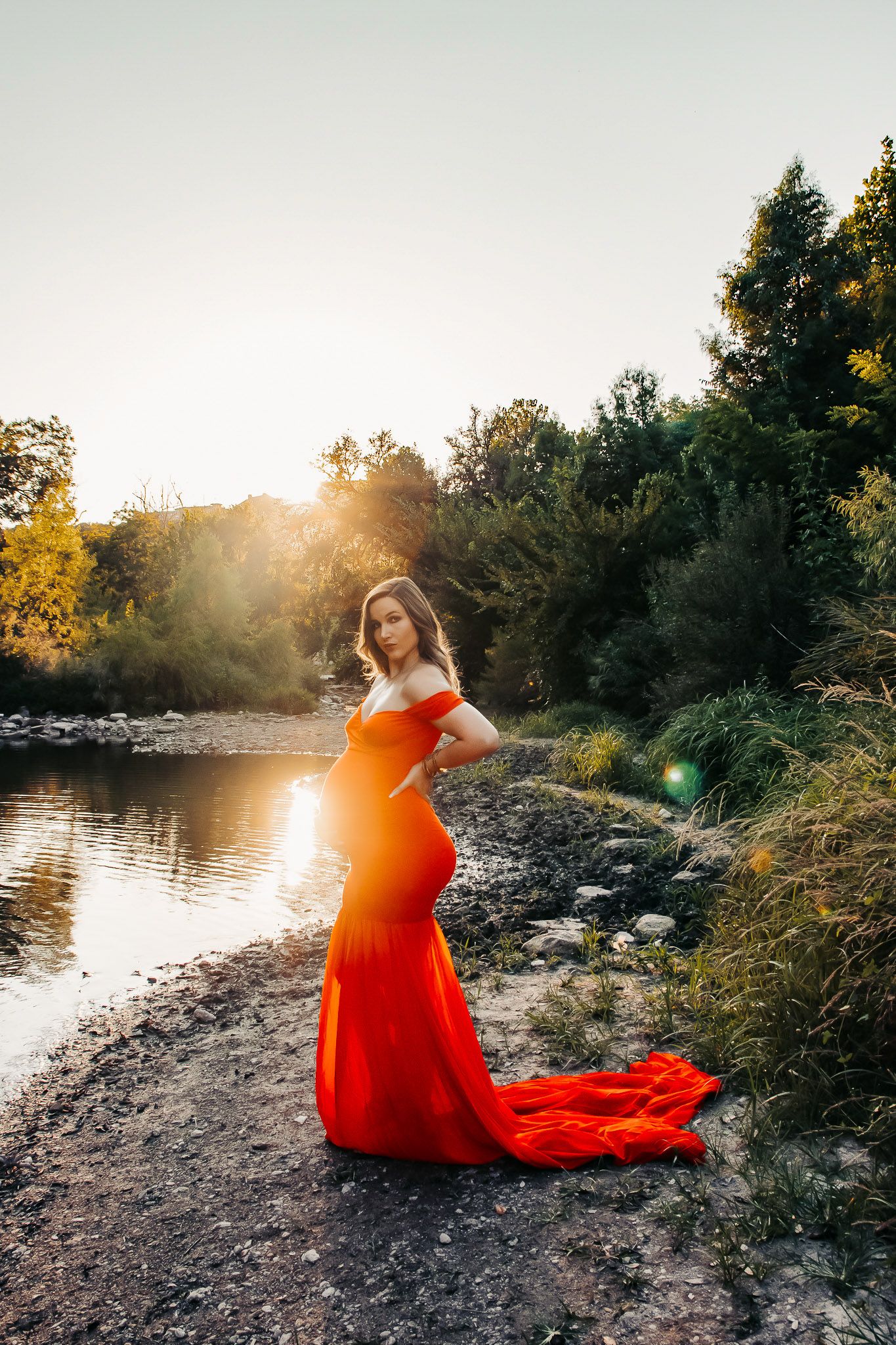 Pregnant woman in a red dress at golden hour, Austin, Texas