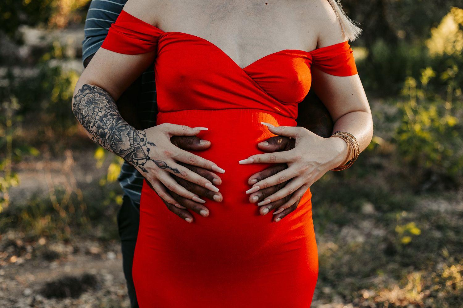 Maternity close-up shot with Mom and Dad's hands on belly