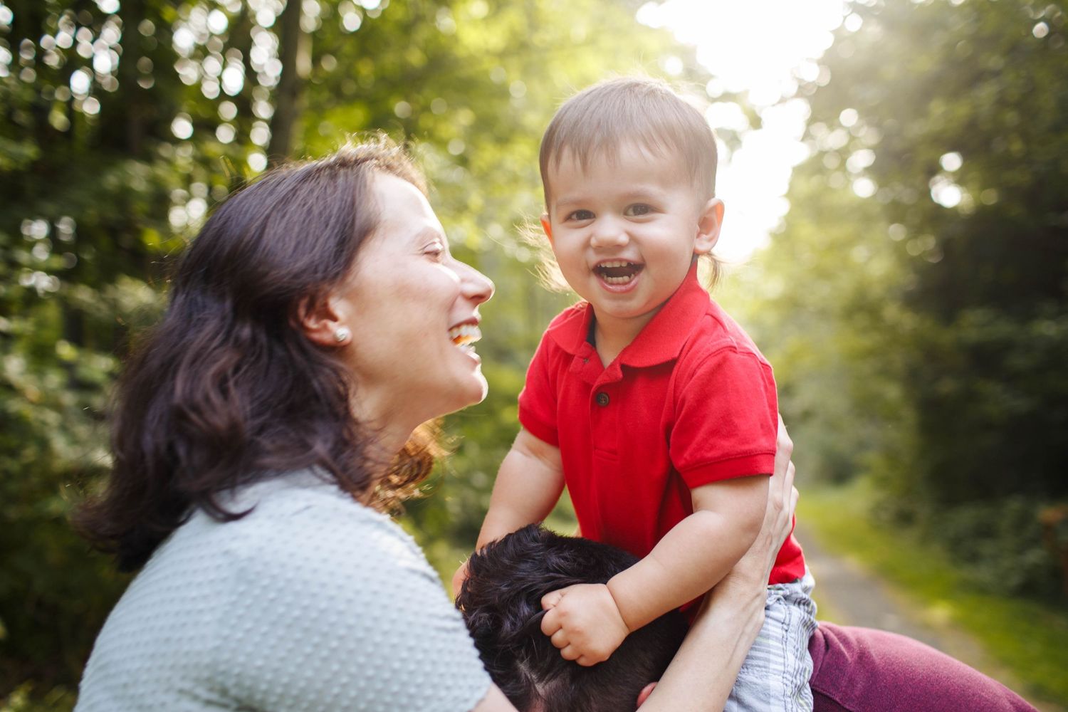 Everett family session: a mother and father play with their toddler during their family session in Willis Tucker Park