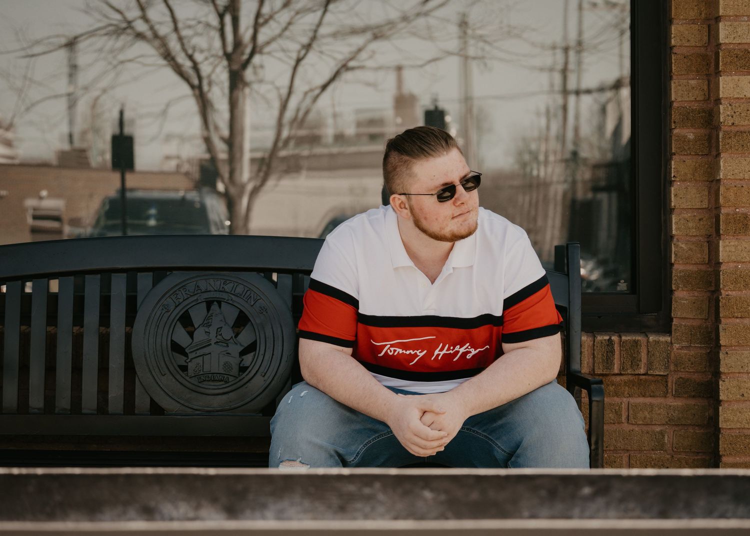 male senior sitting on bench in downtown franklin indiana