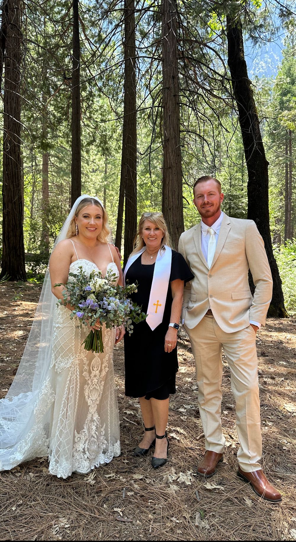 Bride, groom, and parents pose in woods at Yosemite swinging bridge ceremony with officiant