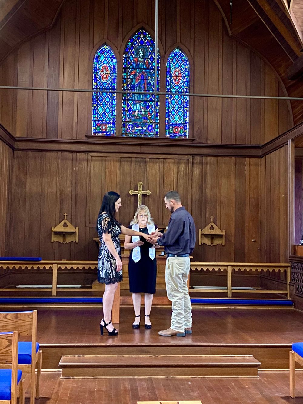 Wedding ceremony at intimate Christian Lodi Chapel, with beautiful stained glass windows and elegant decorations
