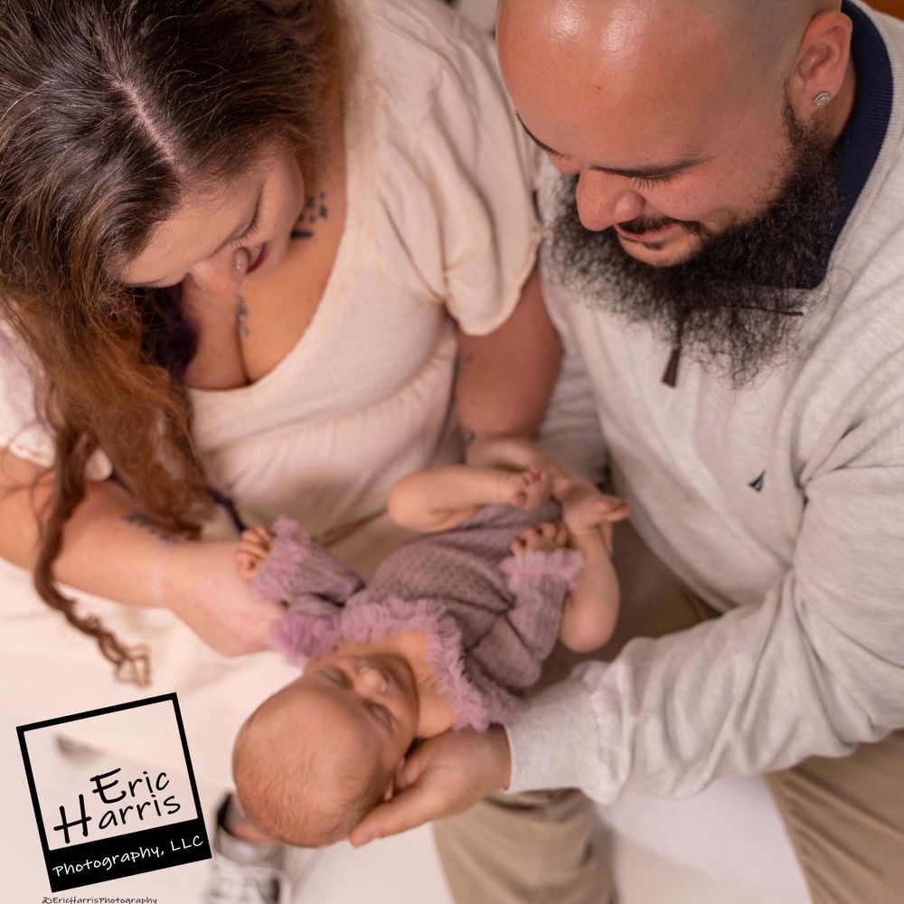 Couple holding their newborn baby girl