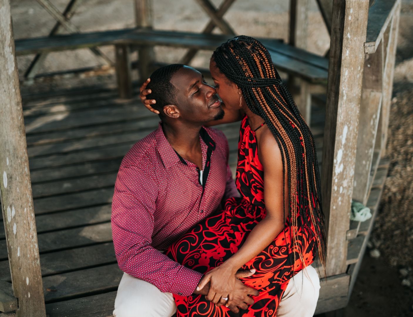 Intimate romantic moment captured on rustic wooden deck.
