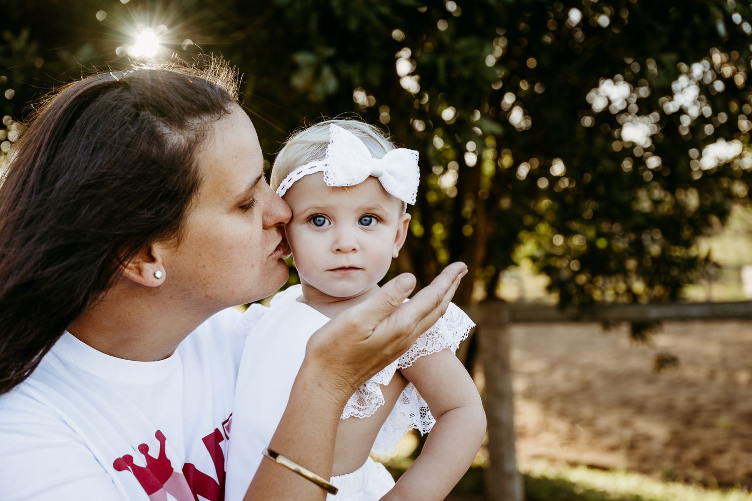 Sweet outdoor moment captured in sunlit garden setting.