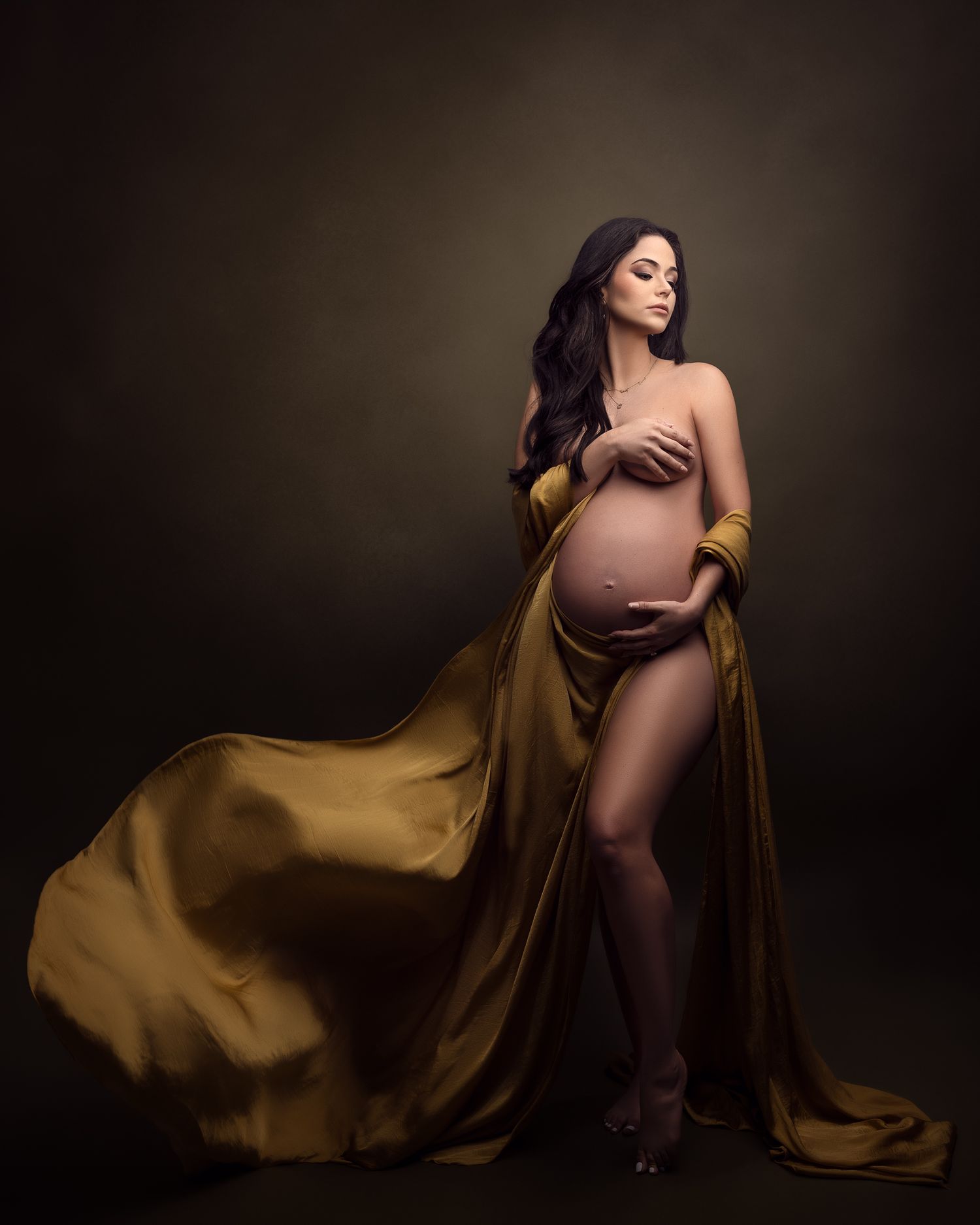 Pregnant woman in golden fabric.Monica Bliss Photography in Raleigh, NC. Newborn, Maternity, Family portrait.