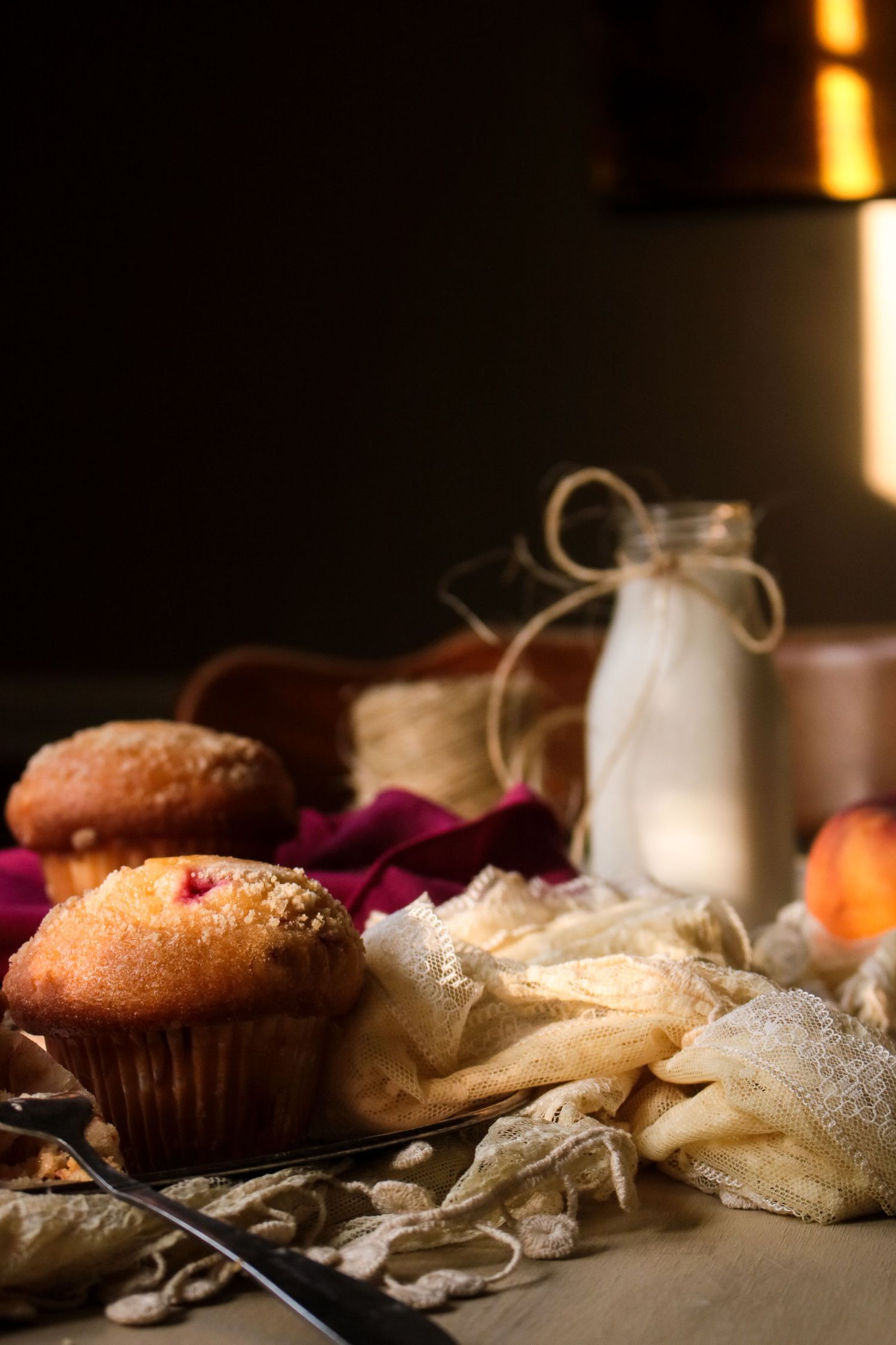 Artfully lit pastries and baked goods displayed with dramatic lighting and shadows.