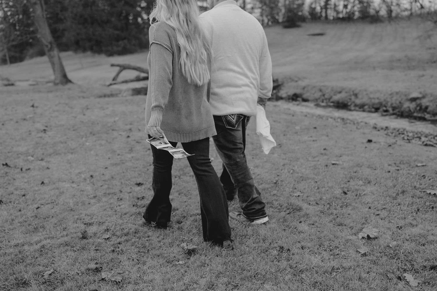 Black and white candid shots of pregnancy announcement in Michigan outdoor photo session.