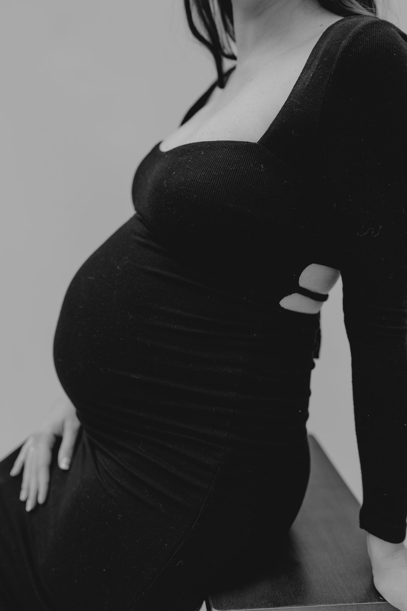 Black and white maternity photos showing silhouette of pregnant belly taken in studio in southern Michigan.