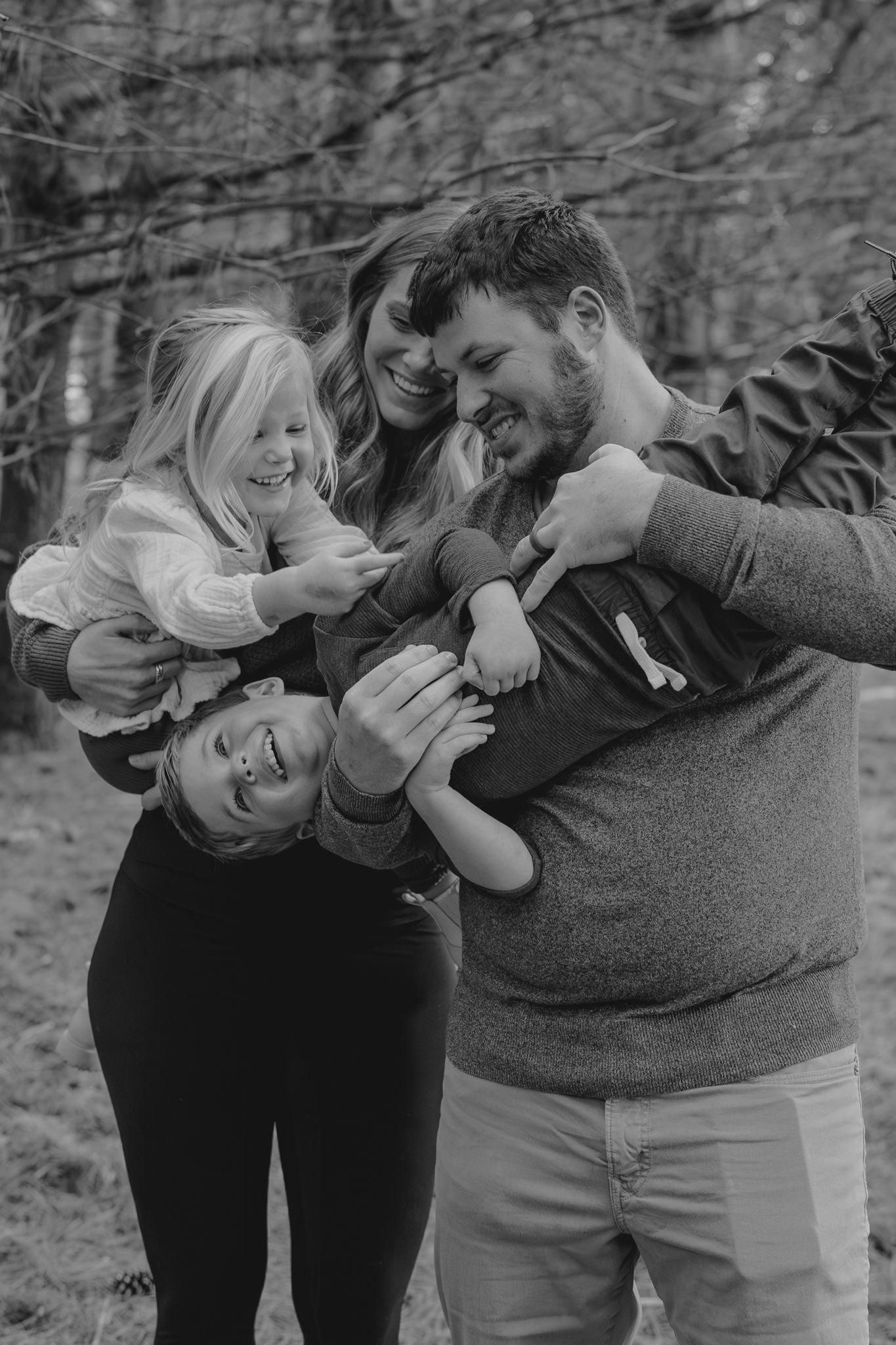 Black and white series of playful family interactions in natural setting in Spring Arbor Mi.