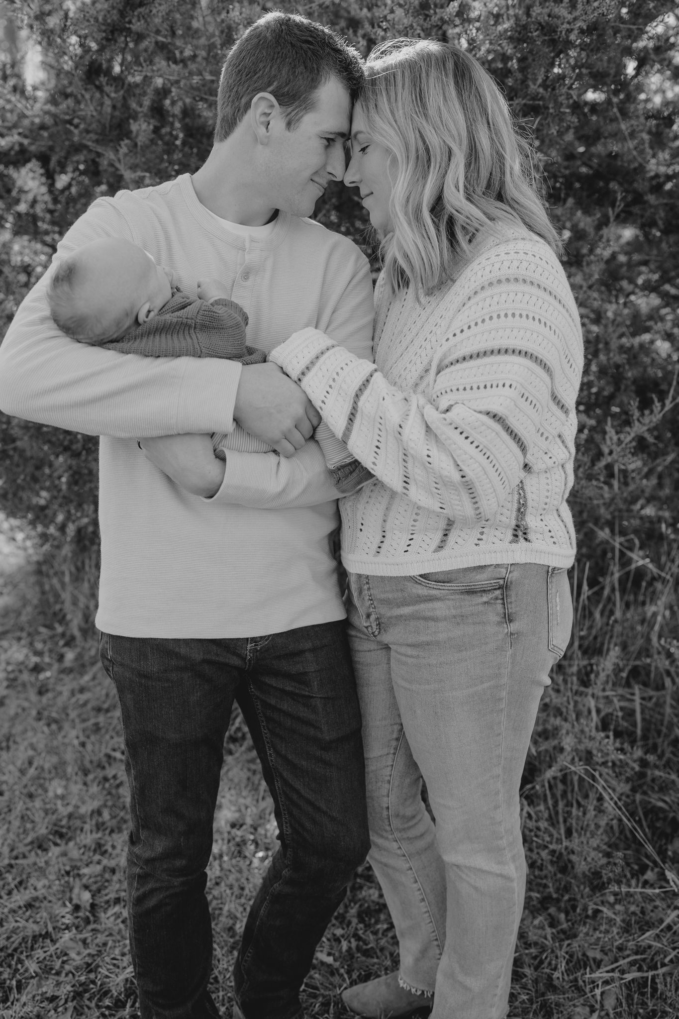 Black and white photos capture intimate moments between a Michigan couple in cozy sweaters.
