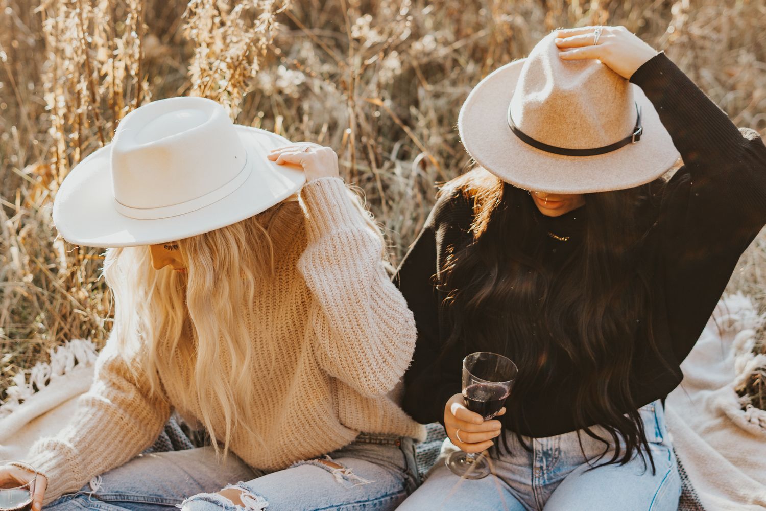 Friends in cozy sweaters and hats enjoying an autumn day outdoors.