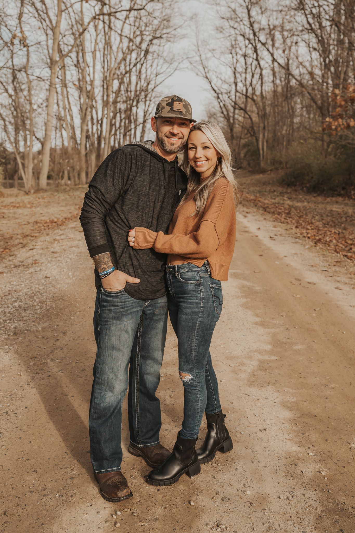 Candid shots of two people in denim walking and embracing on a dirt path.