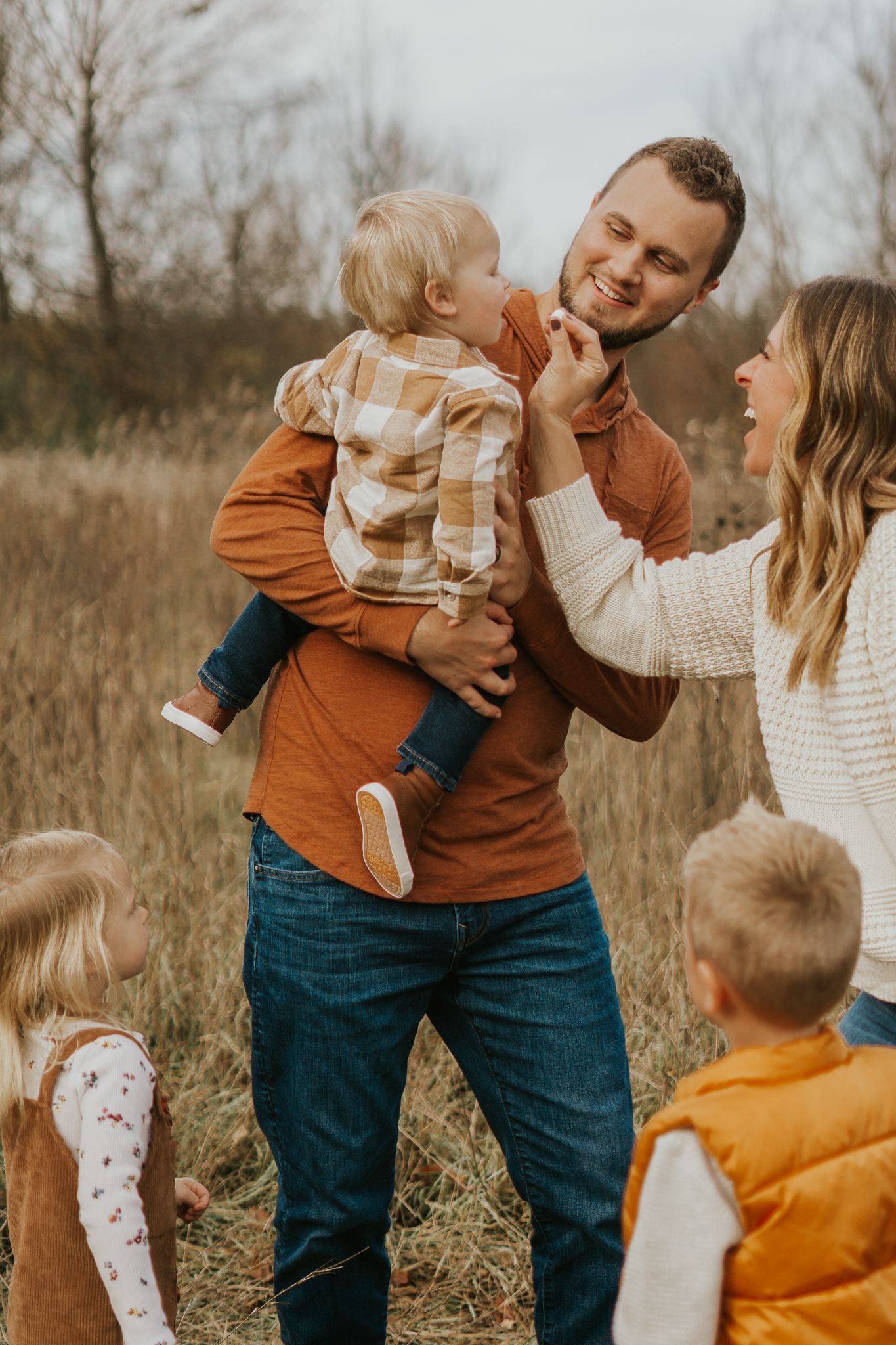 Candid family moments captured in a rustic outdoor setting with warm earth tones.