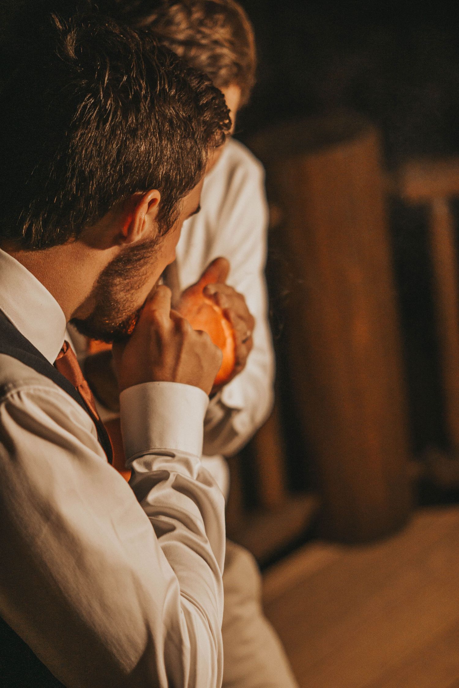 Emotional candid moment captured in warm lighting with dramatic shadows in Colorado Springs.
