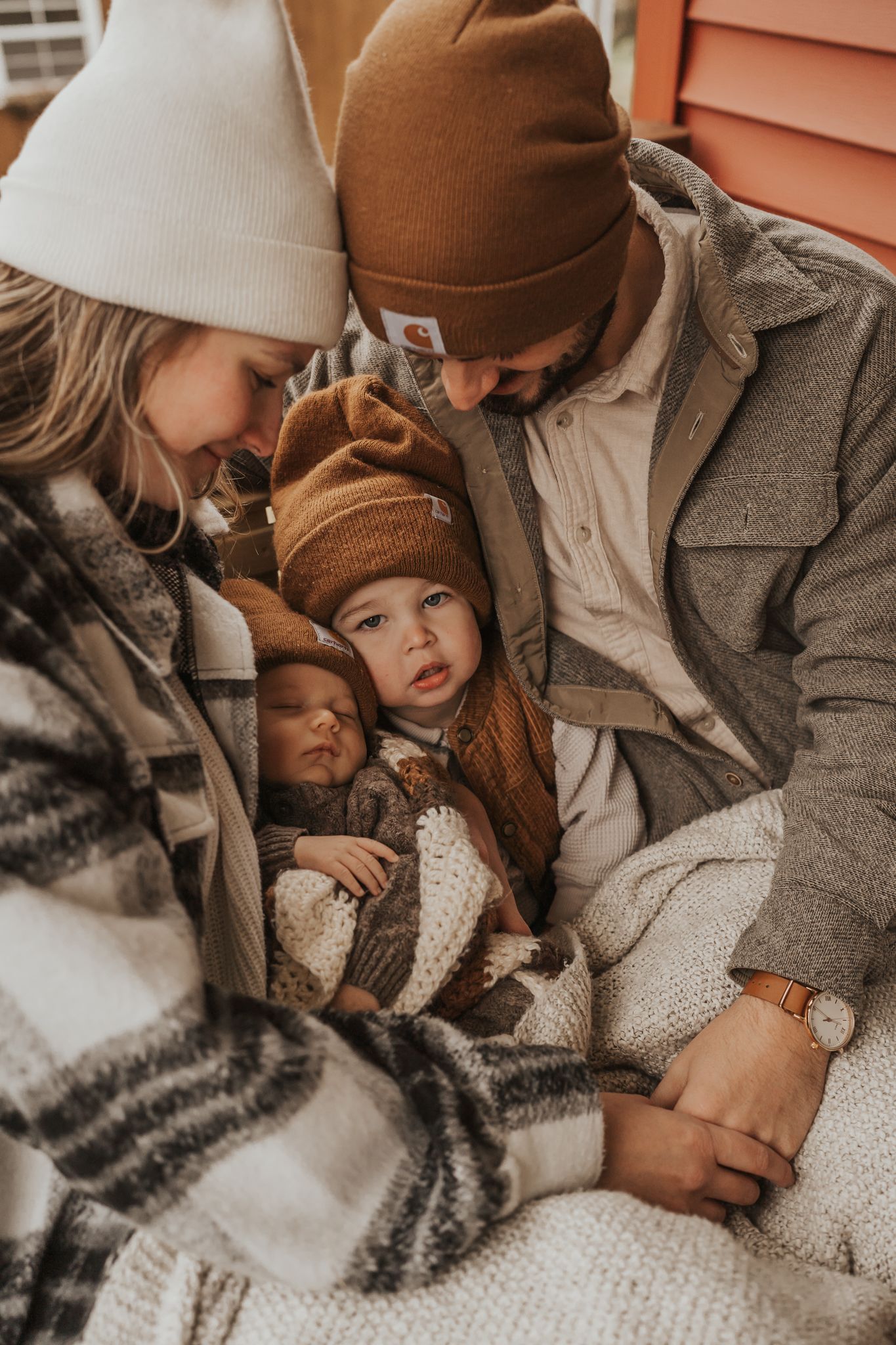 Cozy family moment on blanket with warm autumn tones and natural lighting taken in Chelsea Michigan.