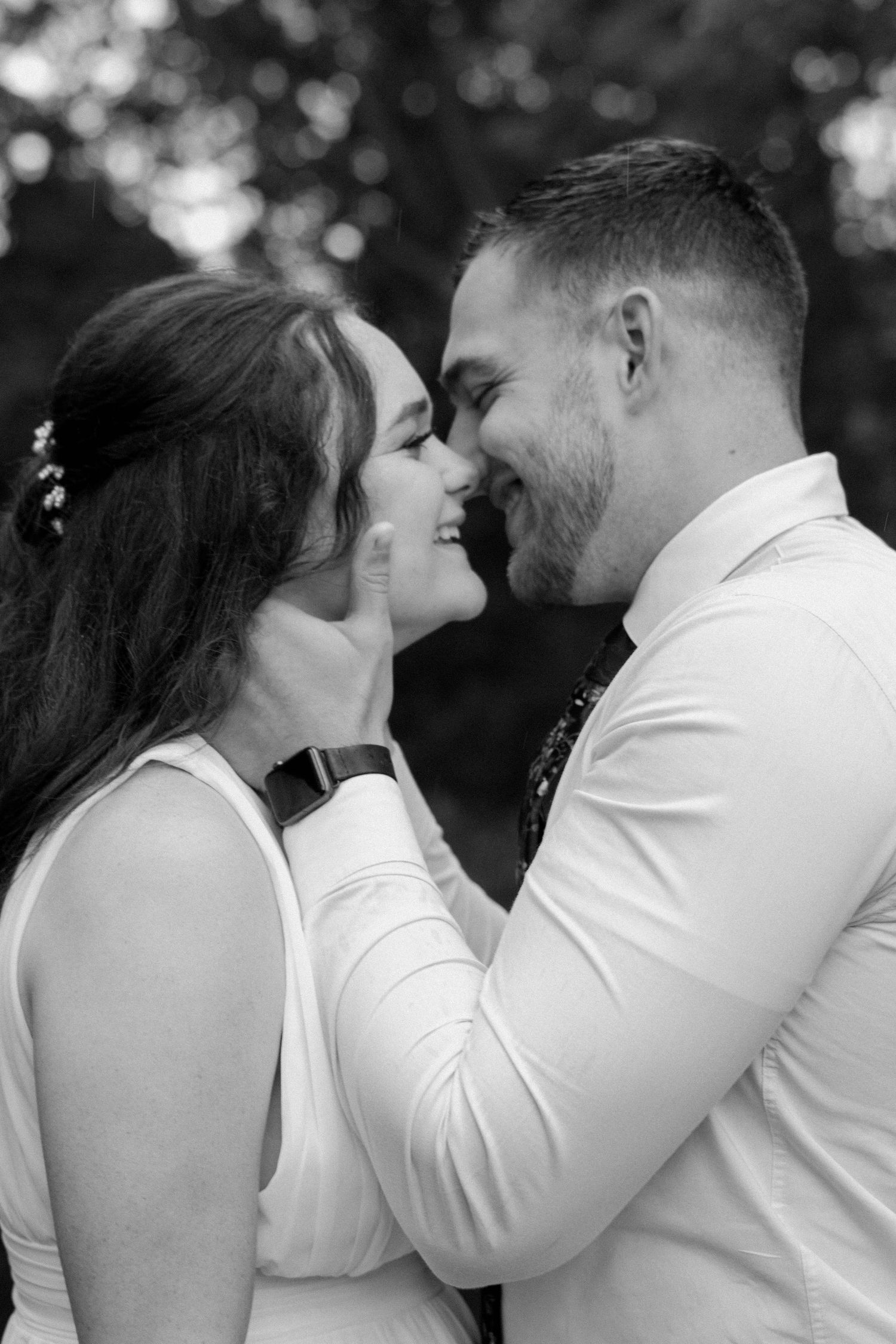 Intimate black and white portrait of a couple in formal attire.