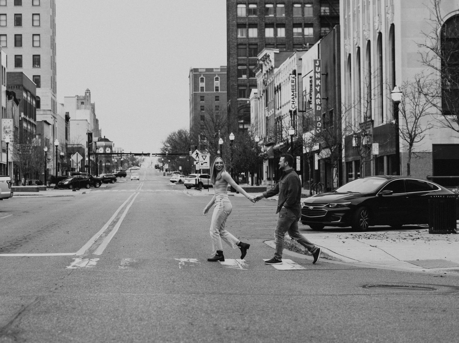 Black and white Jackson MI street scene with couple in romantic poses.
