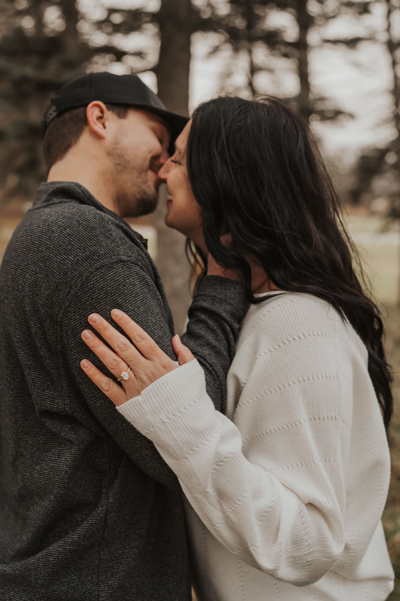 Close-up sequence of romantic couple sharing tender moments against forest backdrop.