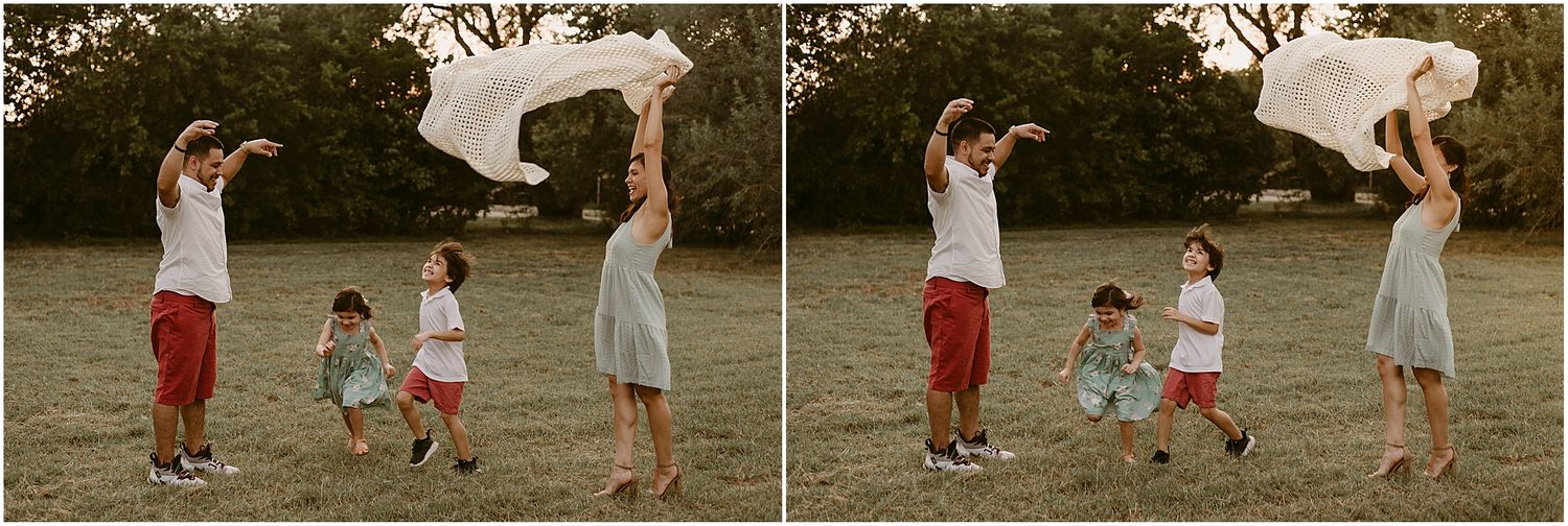 Playful family scene with white fabric creating moments of joy in a park.