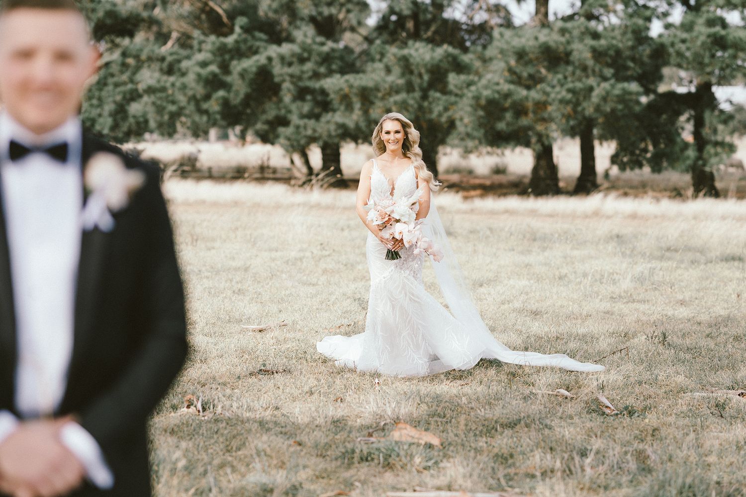 A romantic first look wedding photo captured in an Australian countryside setting.