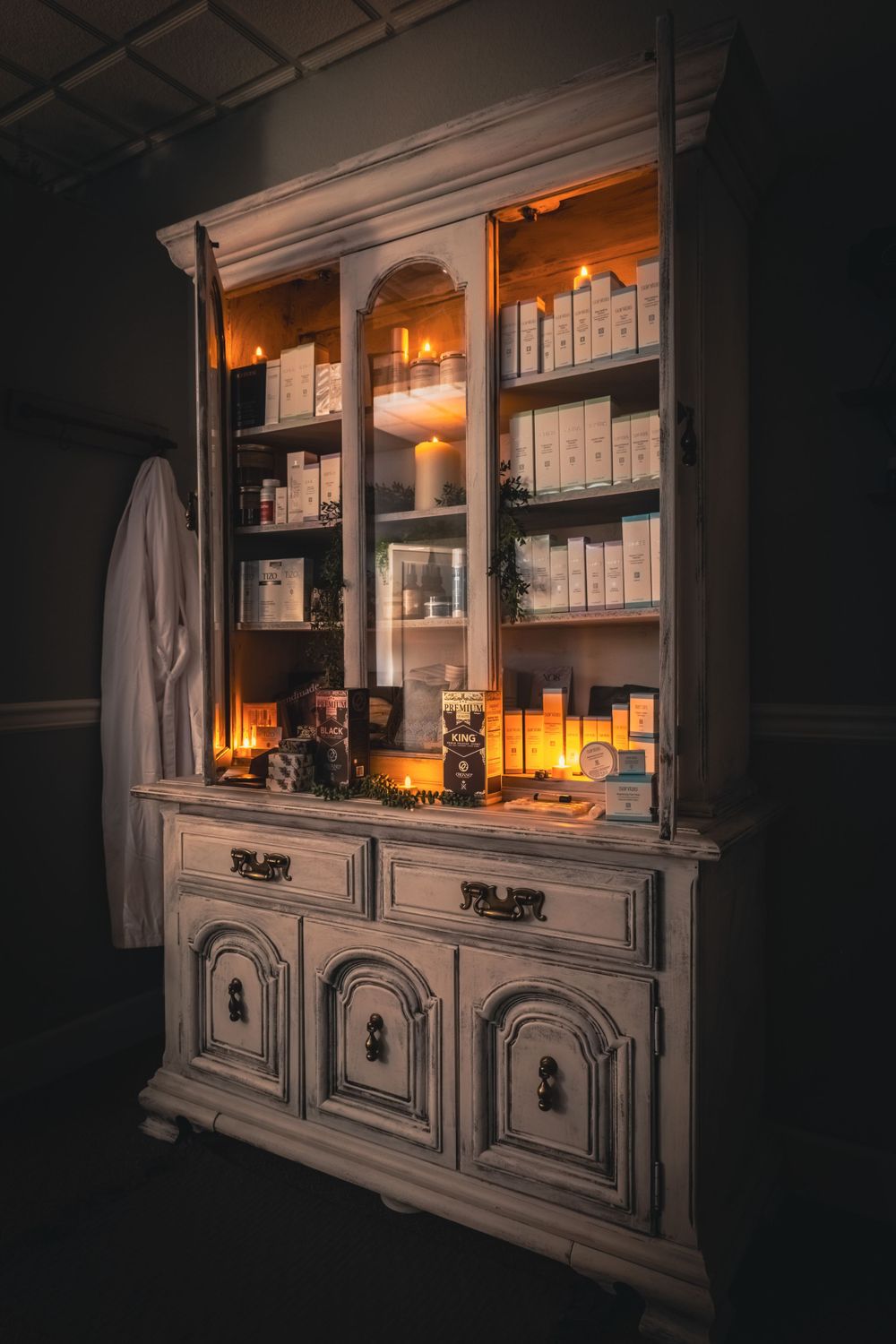 product photo display case containing several items with candle light