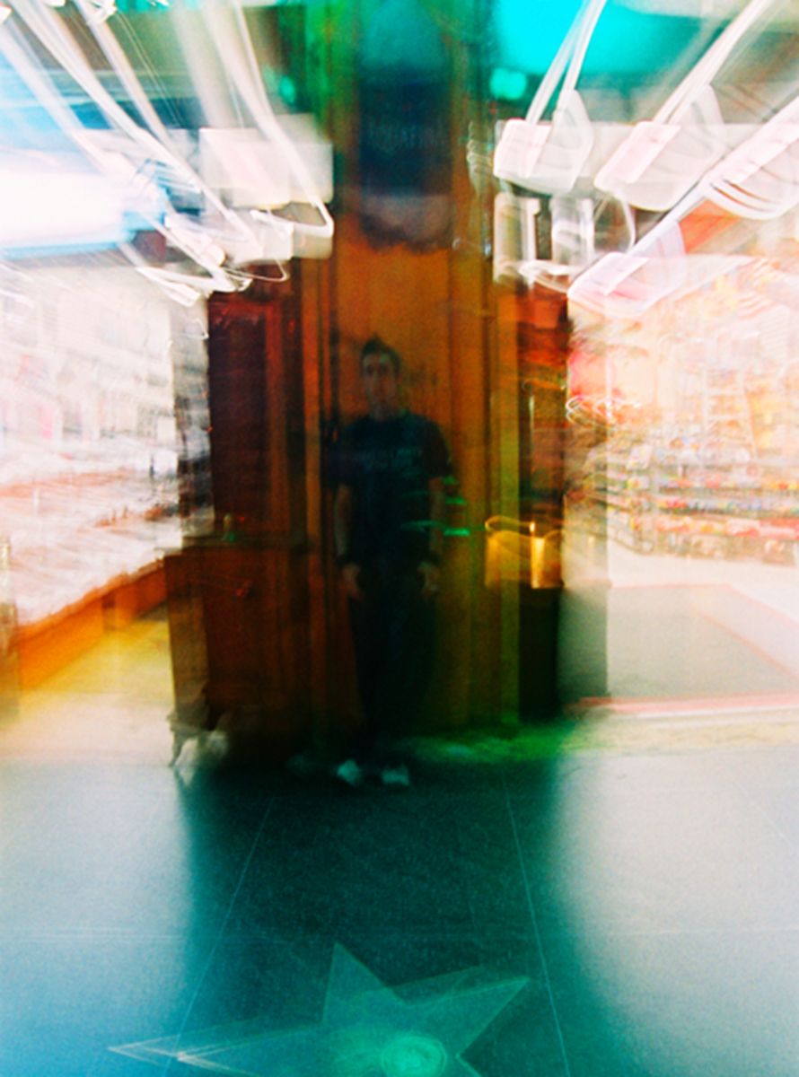 Abstract architectural photograph with multiple exposures in green and blue tones.