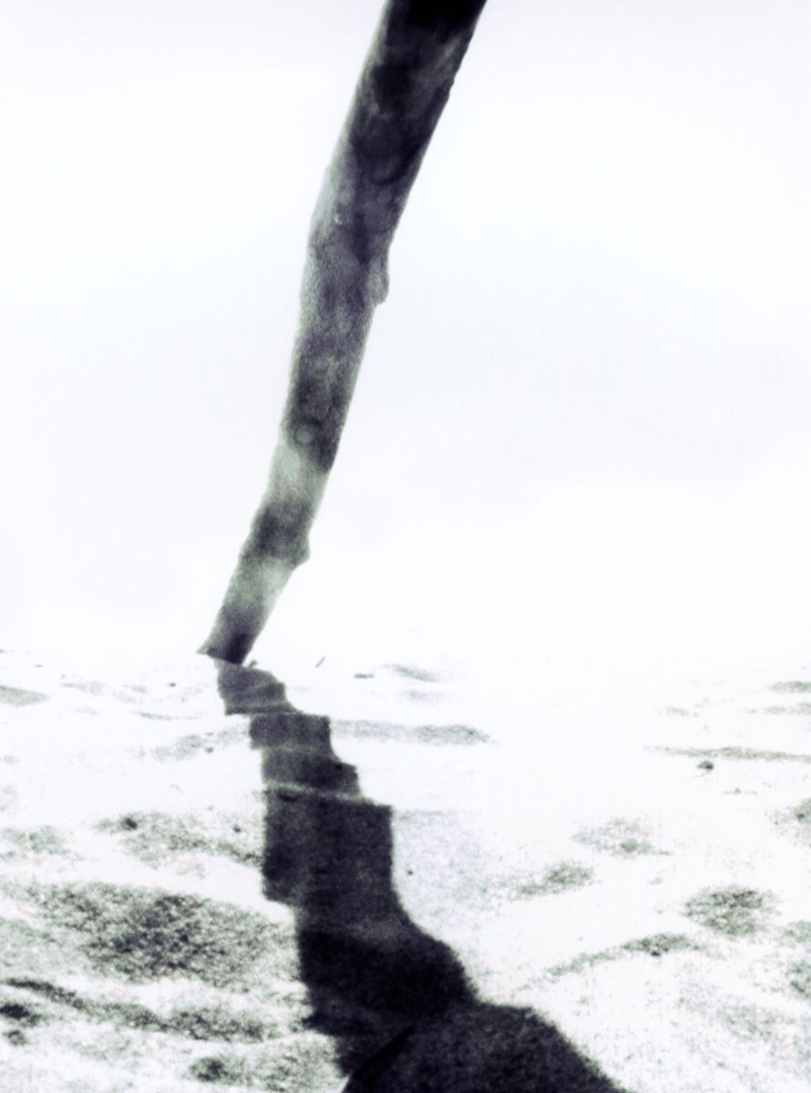 Abstract black and white image of a single line creating shadow on textured surface.