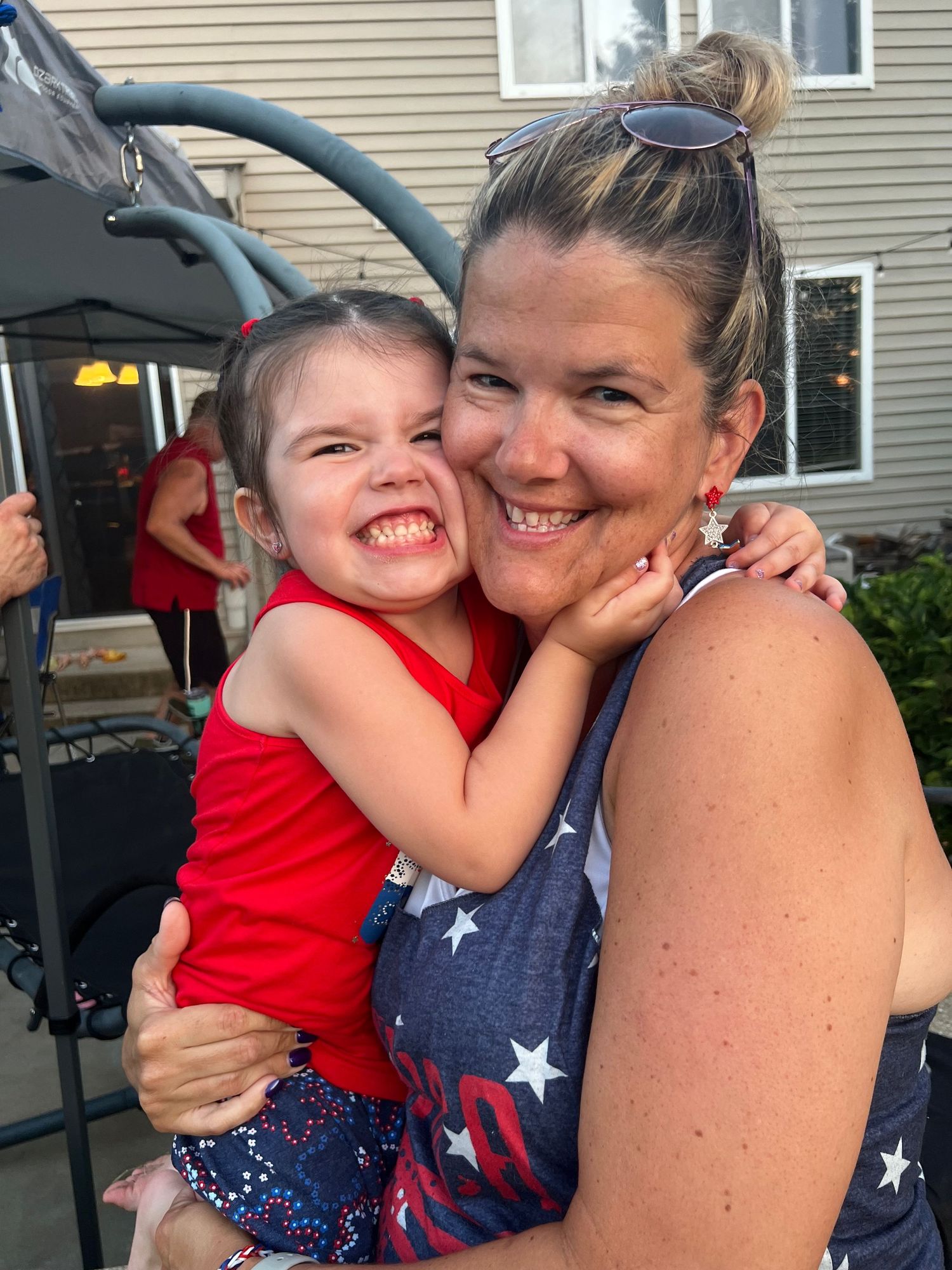 Happy family moment captured outdoors during summer celebration.