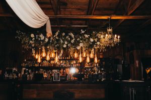 Rustic reception venue with hanging chandeliers and romantic mood lighting.