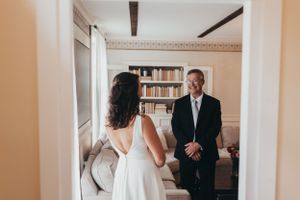 Intimate moment captured in black and white during wedding preparations.