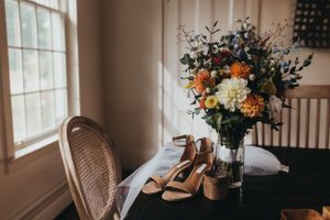 Rustic wedding venue interior with vintage decor and natural light streaming through windows.