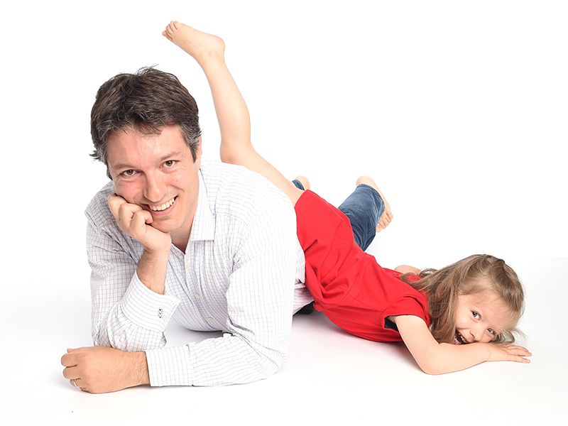 Father and daughter play in relaxed family photoshoot on white background, High Wycombe photographer Abigail's Studio