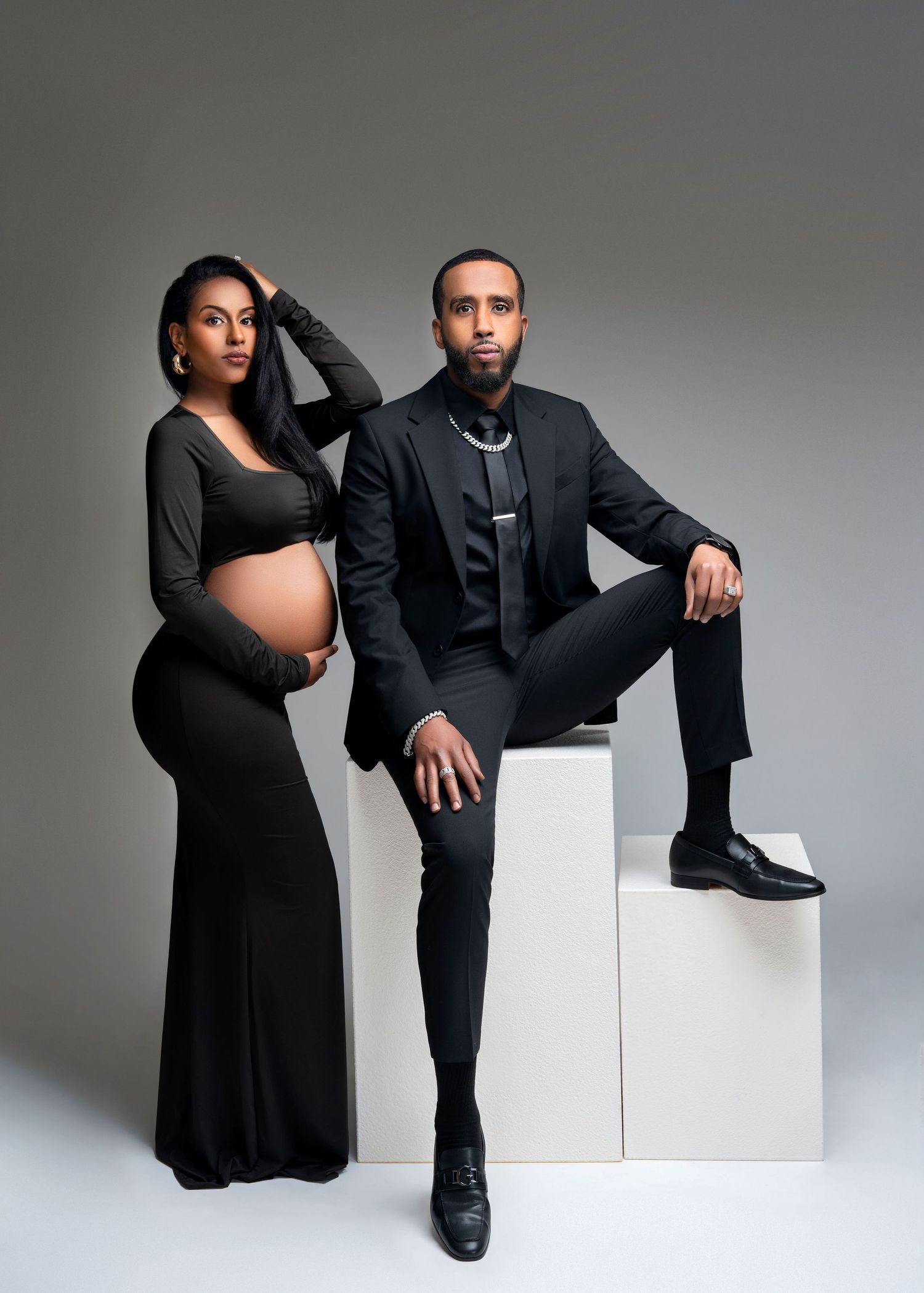 studio maternity photo shoot in minneapolis minnesota, a glamorous couple pose