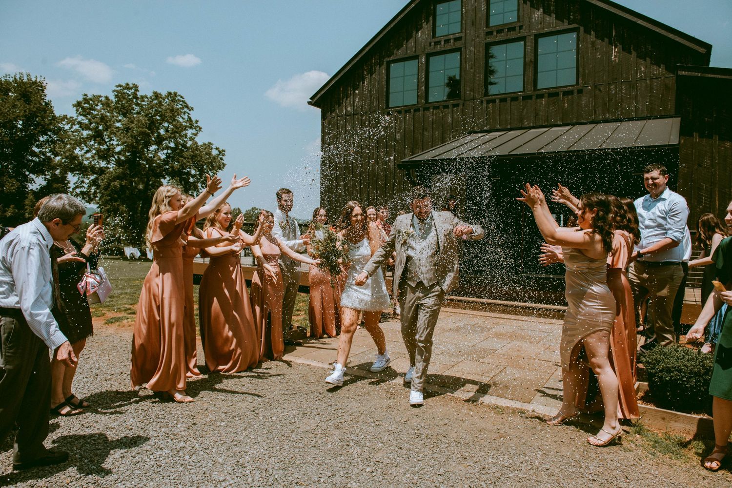 bride and groom having their grand exit from the venue with confetti