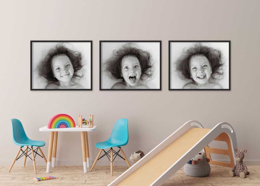 Kids' playroom with a series of black-and-white portraits of a little girl making fun, silly faces in the water, captured by Brandy Aldrich.