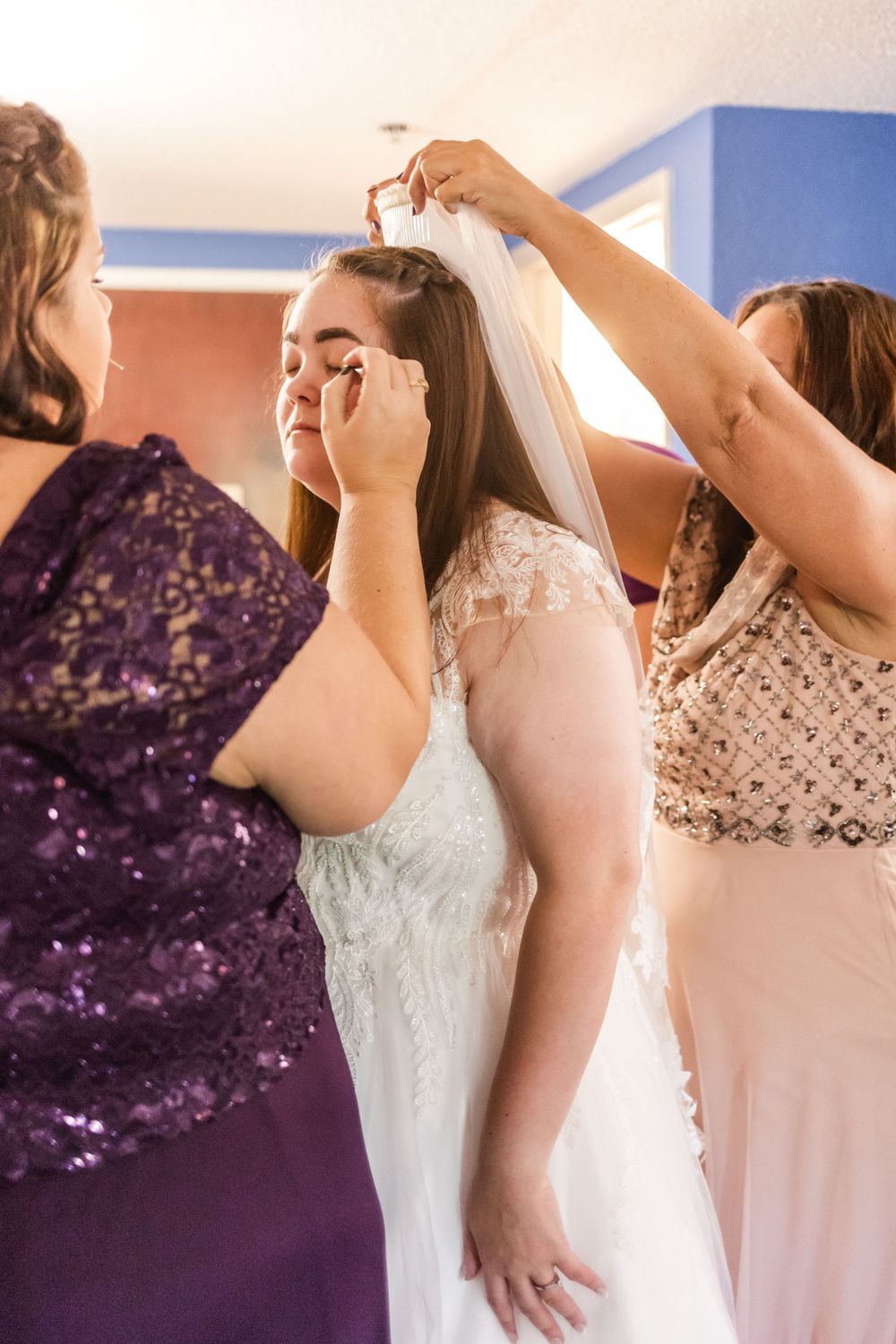 Wedding preparation scene showing final touches being added to bridal look.