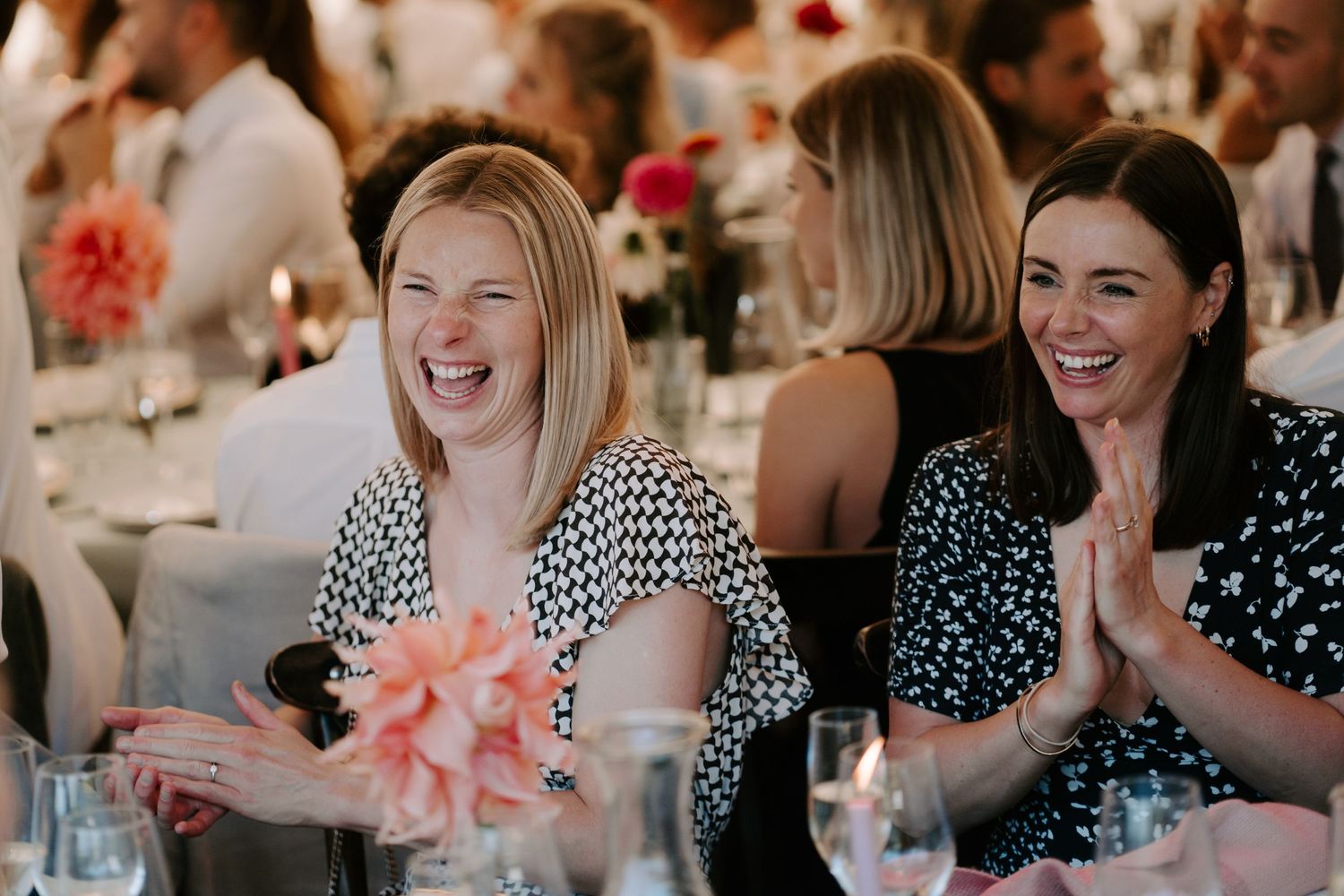 wedding guest laughing at father of the bride speech at wedding in marquee in islip in Oxfordshire