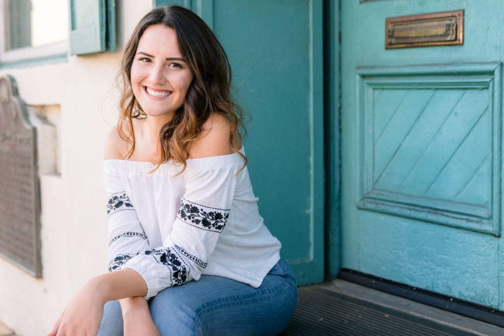 Central Coast Portrait Session Downtown SLO by Felisha Connolly for slo high senior sitting on steps of blue door