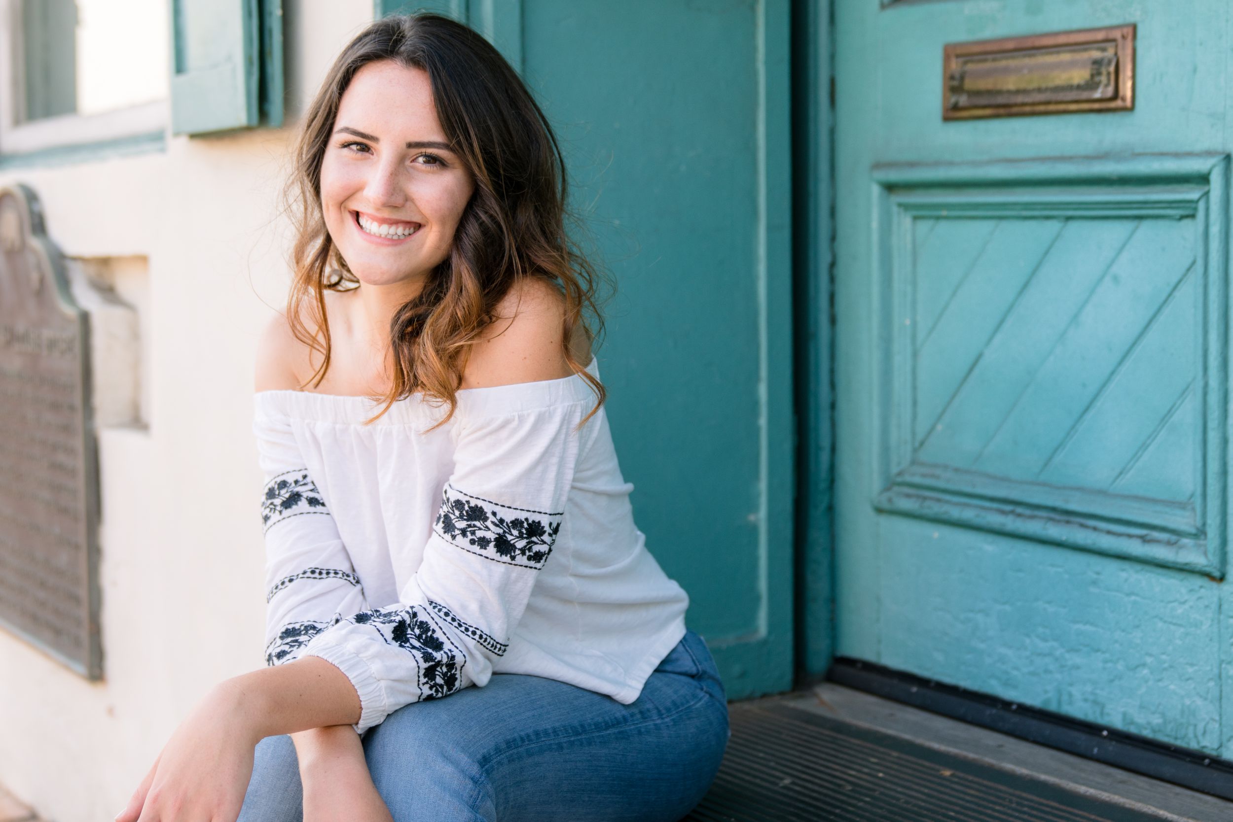 Central Coast Portrait Session Downtown SLO by Felisha Connolly for slo high senior sitting on steps of blue door